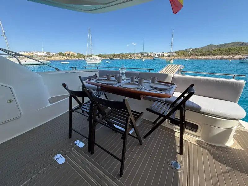 Mesa de la bañera de popa con vistas a la costa de Ibiza